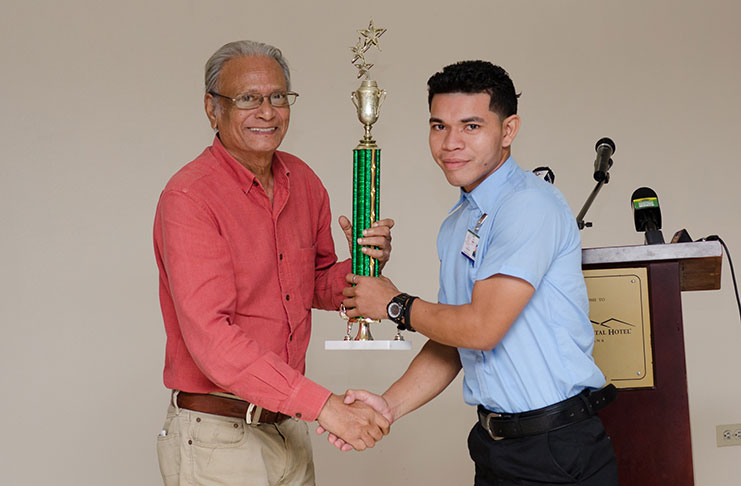 Youth Ambassador 2019, Eion Henry receives his award from Minister of Public Service, Dr. Rupert Roopnaraine
