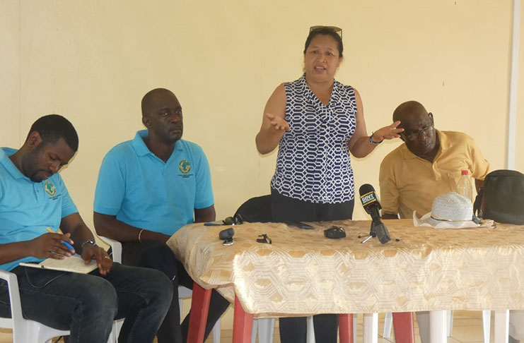 Minister of State, Dawn Hastings-Williams addresses the residents. At her immediate left in CEO of GLSC, Trevor Benn, and other senior officials from the GLSC 