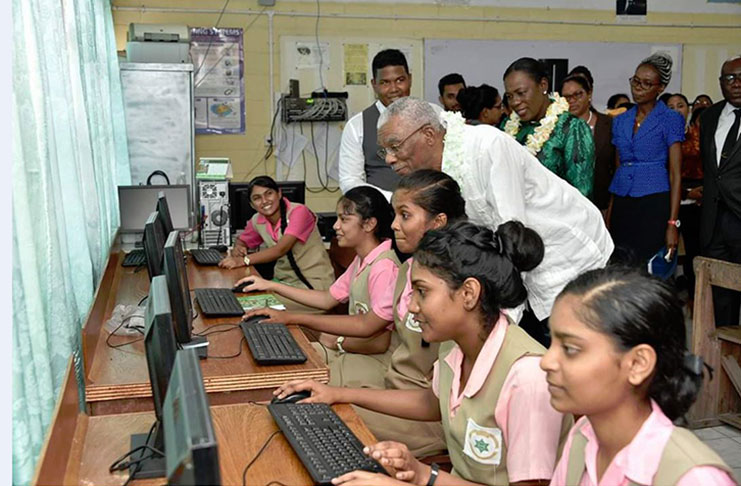 President David Granger engages students of
the New Amsterdam Multilateral School as he
toured the Information and Communication
Technology laboratory. Also photographed
are Minister of Education, Ms. Nicolette Henry
(behind the President), Chief Education
Officer, Dr. Marcel Hutson (right) and Head
Teacher, Ms. Vanessa Jacobs (second right).
(Ministry of the Presidency photo)