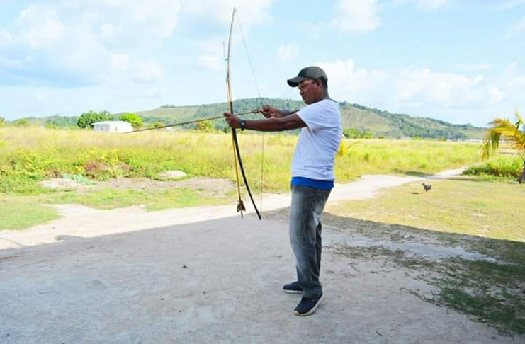 Testing his skills with an arrow and bow at Wowetta Village in the North Rupununi