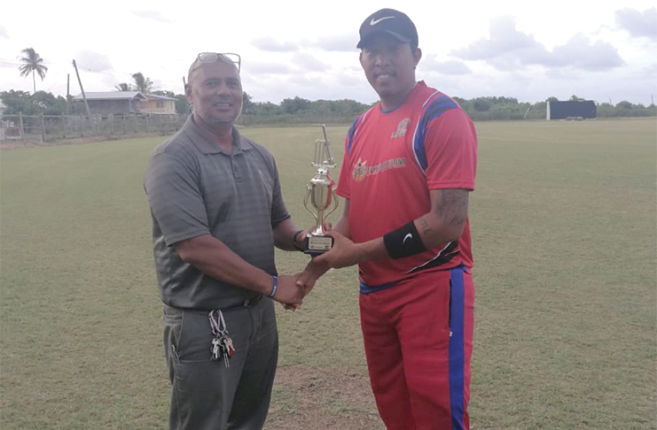 Lower Corentyne's Johnathan Foo collects his MVP award from the match referee, Zahir Moakan