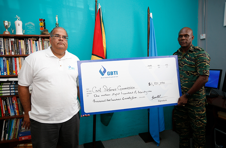 In Photo, GBTI Executive Director Mr. Richard Isava presents the funds raised from the GBTI Hurricane Relief Fund-Bahamas to Director General of the Civil Defence Commission, Col. Kester Craig at the CDC's office