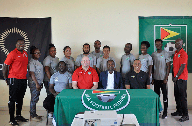 Some of the participants at the Concacaf Next Play Coaches Workshop take a photo with head table officials from right: Andre Virtue, Wayne Forde, Ian Greenwood and Nigel Linton.