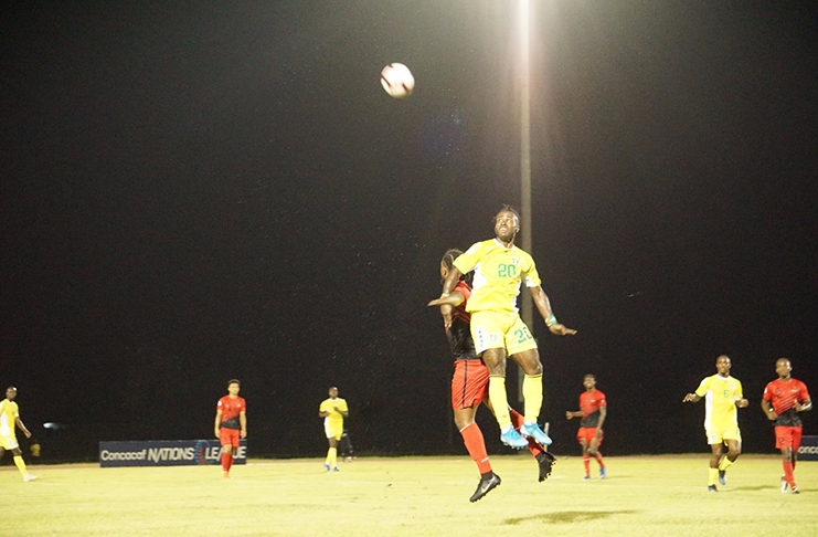 Trayon Bobb, the star of Guyana’s 5-1 win over Antigua and Barbuda, goes airborne for a ball during the contest at the National Track and Field Centre. (Carl Crooker photo)