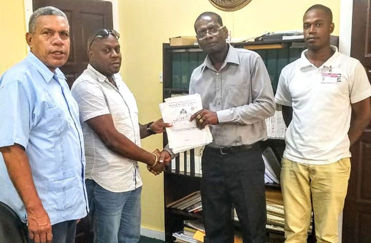 Regional Chairman Gordon Bradford (left) stands alongside contractor J Jordan; Regional Executive Officer, Kerwin Ward (second right)  and Regional Engineer Selwyn Charles (right).