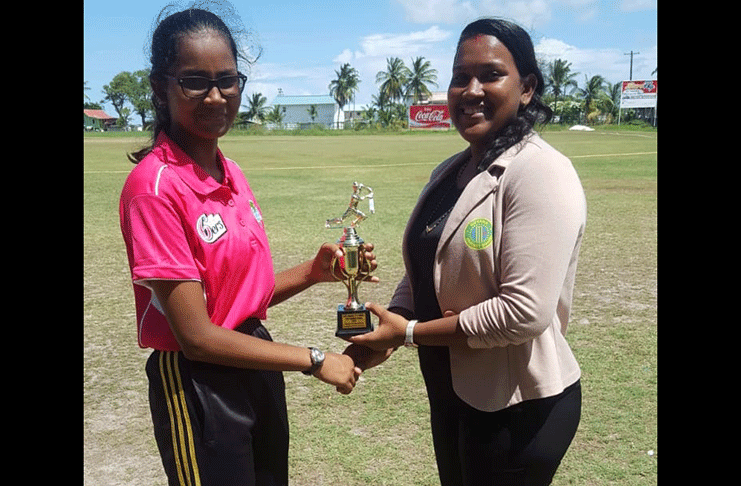 Arheanna Persaud accepts her MVP trophy from Assistant Territorial Development Officer Kavita Yadram