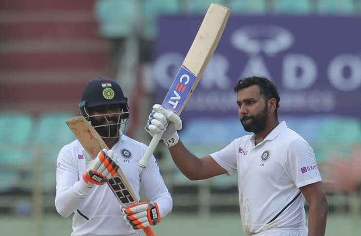 India's Rohit Sharma raises his bat after scoring a century during the fourth day of the first cricket Test match against South Africa in Visakhapatnam, India, yesterday.