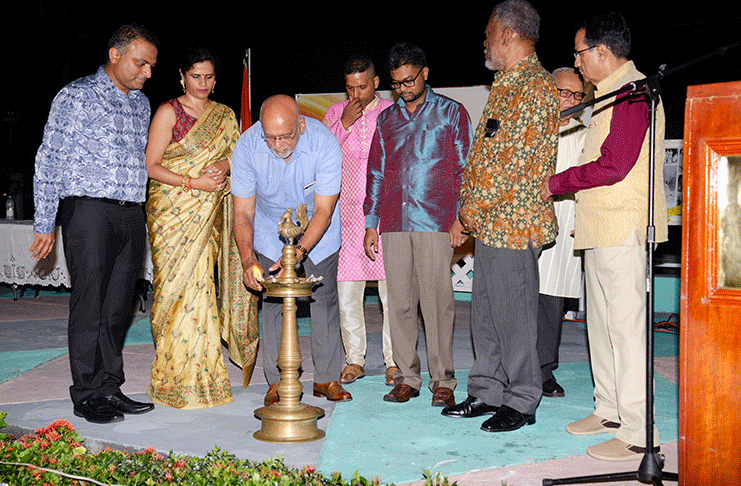 Former President, Donald Ramotar lights the ceremonial lamp in observance of Diwali as Indian High Commissioner, Dr. K J Srinivasa, his wife Ashwini Srinivasa; Mayor of Georgetown, Pandit Ubraj Narine; former Prime Minister, Samuel Hinds, and others, look on