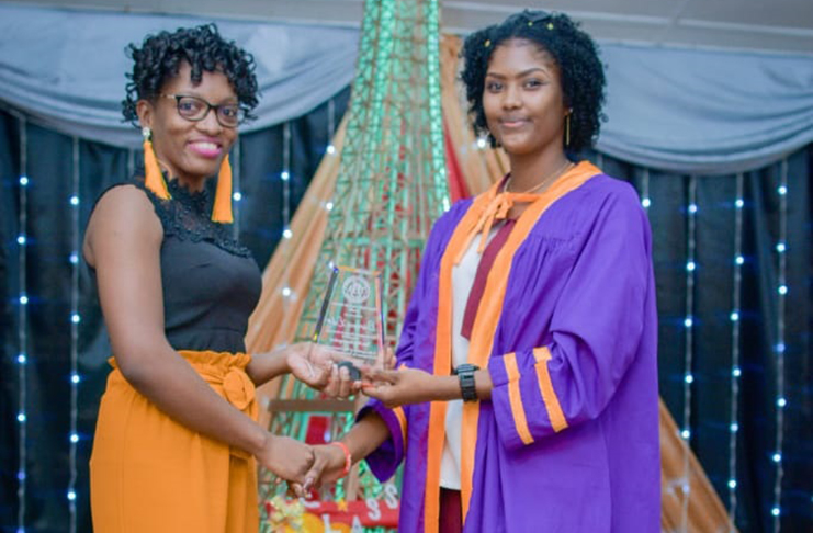 Tamya Healis (left) handing over her award to Oureana Lake