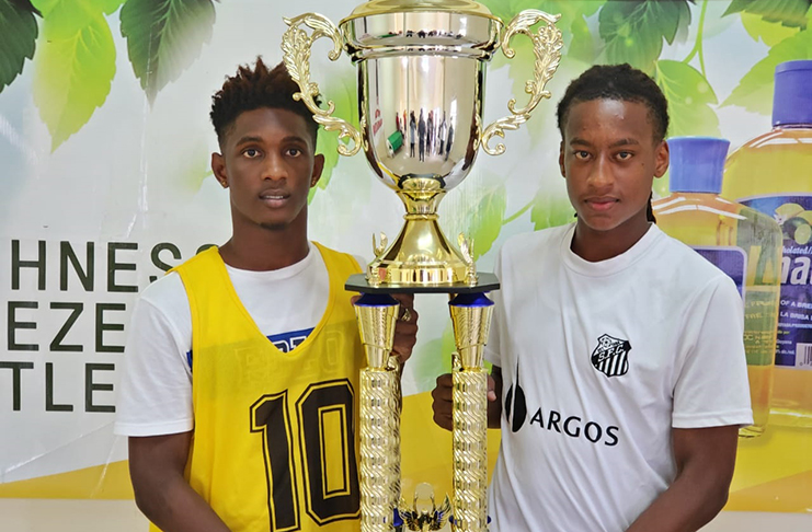 Calm before the storm! Nicholas McArthur (left) of Fruta Conquerors U-20 shares the trophy with his opposite number Marcus Willson of Santos U-20.