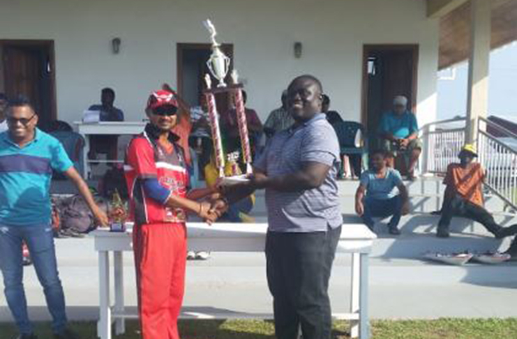 Skipper and Man-of-the-Match Yogeshwar Lall accepts the winners’ trophy from CECC representative Autto Christiani.