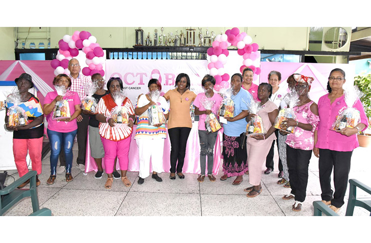 Mr. Andrew Carto, Human Resources Director and Dr. Latoya Gooding pose with cancer survivors