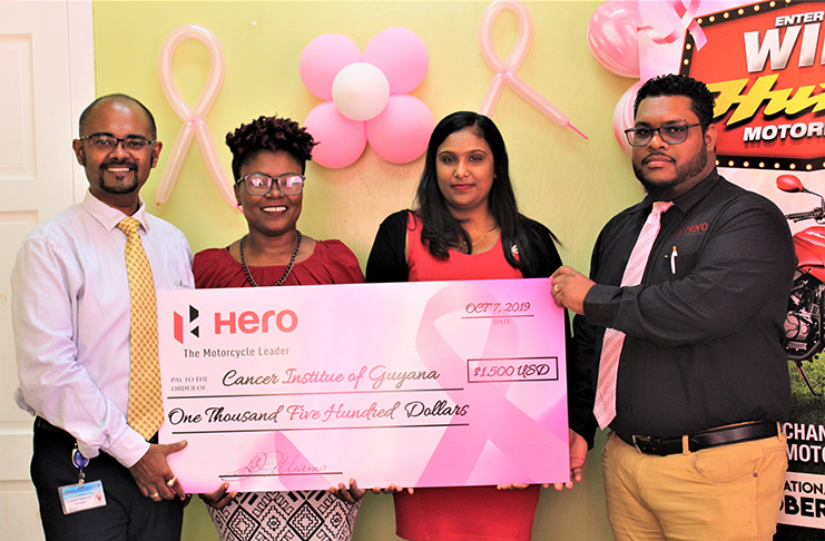 Dr Sayan Chakraborty (left) receives the donation from Deon Williams (right) in the presence of Monette Harry (second left) and Kamla Mohan.