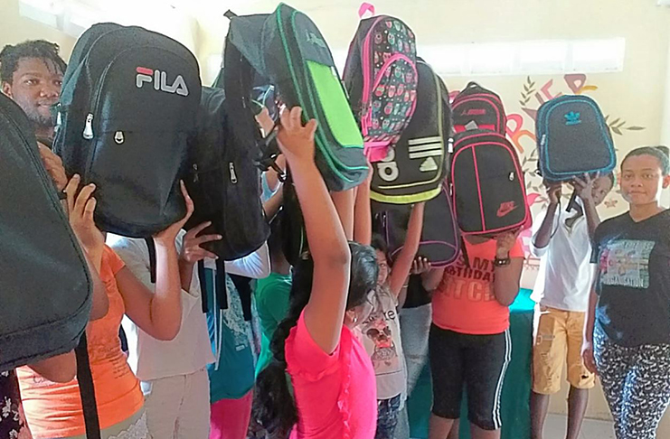 A scene from the recent back-to-school drive on Hogg Island, where several children received school supplies