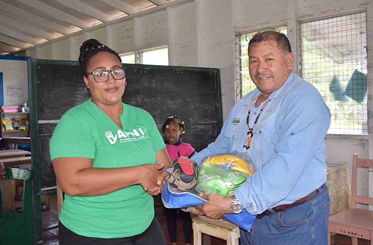 Melissa Pritchard, Chairperson of the CDC, receiving the sport gear from Minister of Indigenous Peoples’ Affairs, Hon. Sydney Allicock
