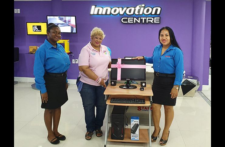 Founder of the Guyana Cancer Foundation, Bibi Hassan, received the computer from HP Product Sales and Marketing Manager, Penny Francis, in the presence of another staff