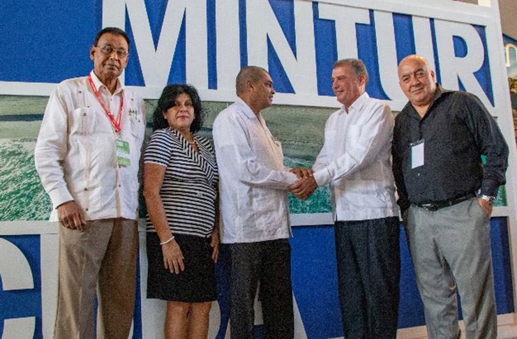 Minister of Business Haimraj Rajkumar meeting with Cuba’s First Vice-Minister of Tourism, Luis Miguel Diaz Sanchez. With them are Guyana’s Ambassador to Cuba Halim Majeed (left), and members of the Cuban delegation at the fair
