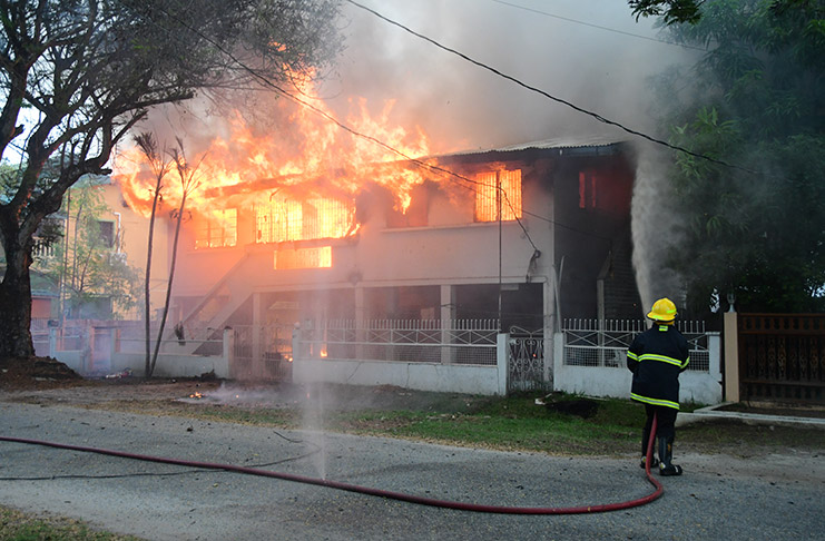 A fireman tries to control the blaze