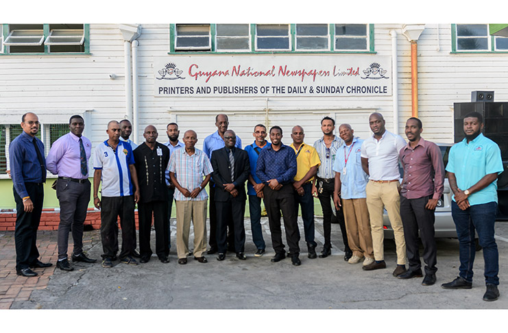 Editor in Chief, Nigel Williams (center) flanked by some of the men of GNNL on International Men’s Day at the Guyana Chronicle. (Delano Williams photo)