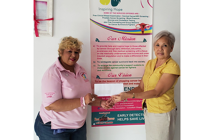 GMR&SC Office Executive Cheryl Gonzalves hands over the donation to the Guyana Cancer Foundation head Bibi Hassan