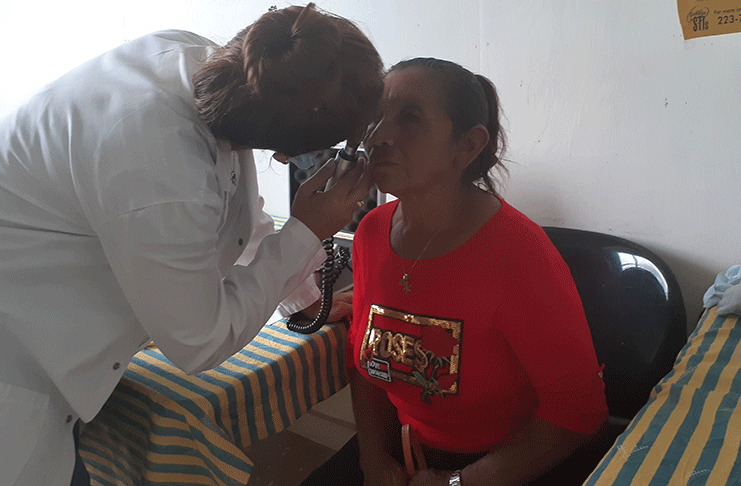 An optometrist screening the eyes of an Upper Mazaruni resident