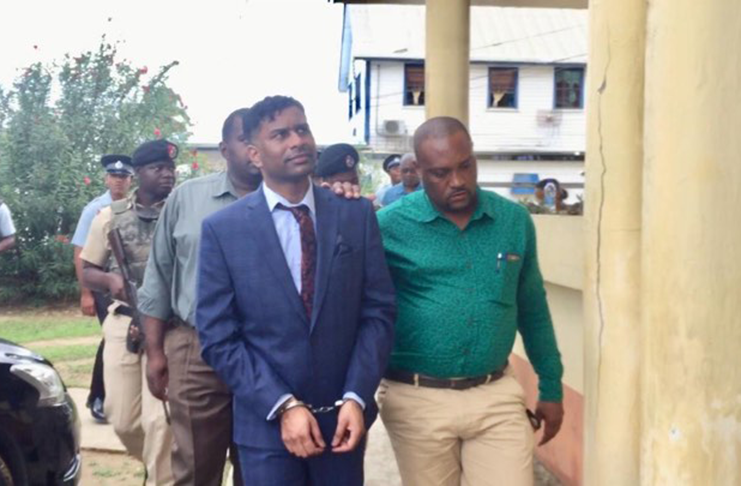 Marcus Brian Bisram being escorted into the Whim Magistrate’s Court on Thursday