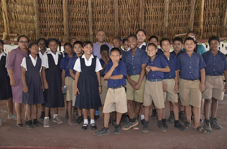 Director, Department of Energy, Dr. Mark Bynoe and students of the Arapaima Primary School