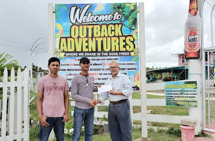 President of the BCA, Krishnanand Raghunandan, (right) receives sponsorship cheque from Operations Manager of R. Sookraj & Sons Outback Adventures, Havendra Sookraj, (centre) in the presence of vice-president Steve Leung (left).