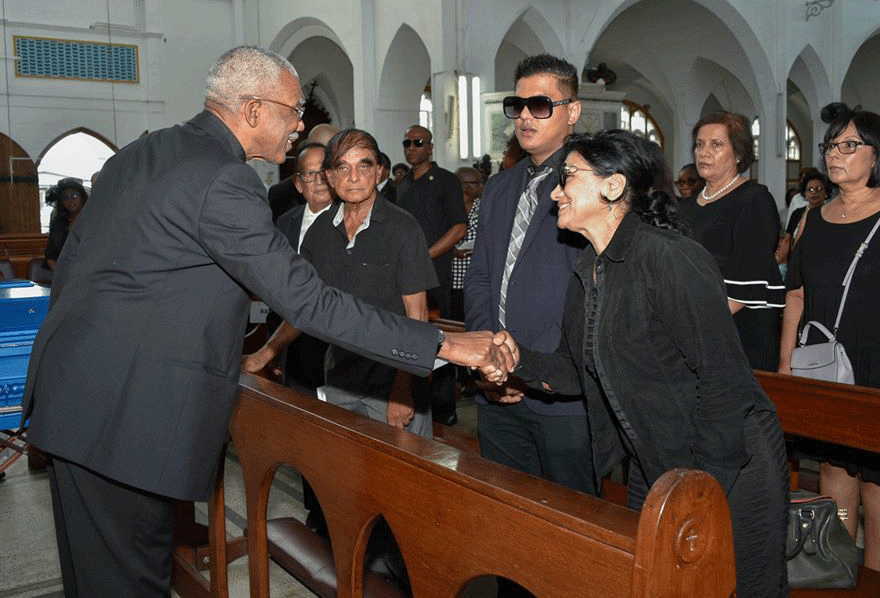 President David Granger greets a relative of Dr Hanoman at the funeral service at the Cathedral of Immaculate Conception on Friday