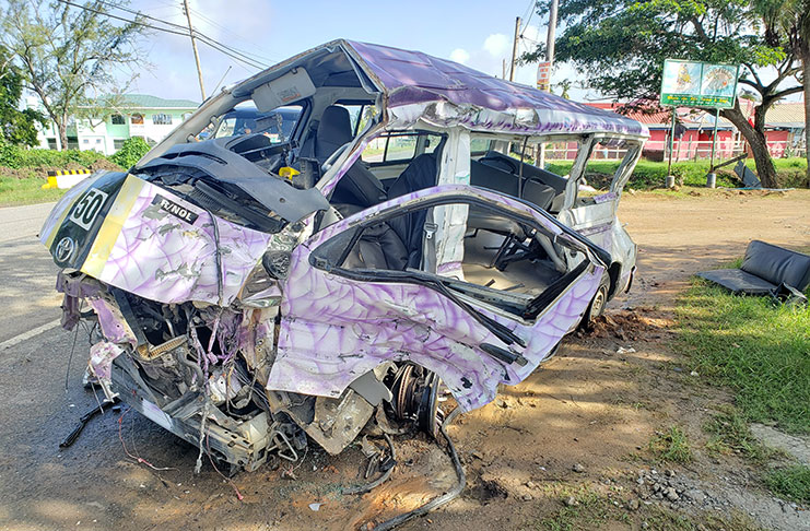 The mangled remains of the minibus was still at the scene of the accident on Thursday