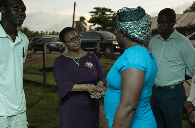 Minister of Public Health, Volda Lawrence, extending condolences to the Sealey family in the company of Regional Health Officer, Dr. Desmond Nickholson 0