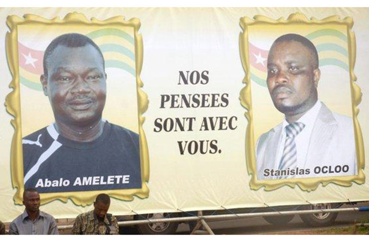 A billboard pays tribute to assistant coach Amalete Abalo and media officer Stanislas Ocloo