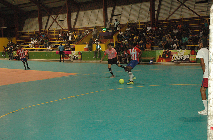 Action between North-East La Penitence (red) and Avocado Ballers in the Magnum Tonic Wine Mashramani Cup Futsal at the National Gymnasium, Mandela Avenue