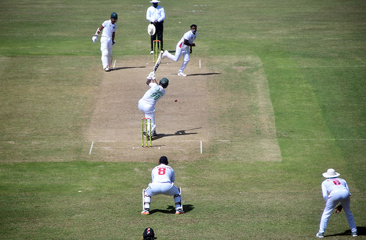 Tagenarine Chanderpaul looks on as Chris Barnwell drives down the ground during their 86-run partnership for the fifth wicket. (Adrian Narine photo)