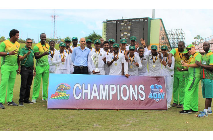 Fashback! CWI Director of Cricket, Jimmy Adams, and GCB Secretary, Anand Sanasie, pose with the champion team- Guyana Jaguars at Providence in 2019.