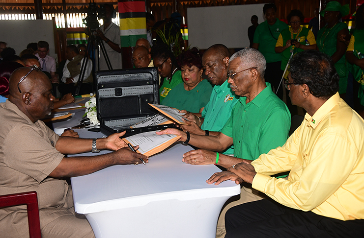 Presidential Candidate of the APNU+AFC, David Granger, and his Prime Ministerial Candidate, Khemraj Ramjattan, submitting their List of Candidates to the Chief Elections Officer, Keith Lowenfield (Photo by Adrian Narine)