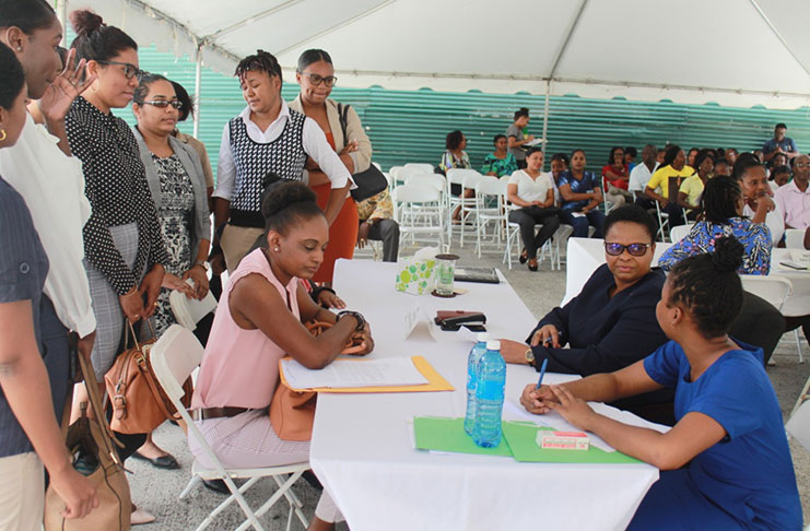 A group of persons engaging Minister of Public Health, Volda Lawrence about their concerns (Vishani Ragobeer photo)