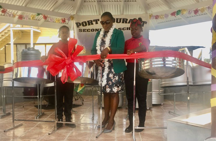 Education Minister Nicolette Henry being assisted to cut the ceremonial ribbon