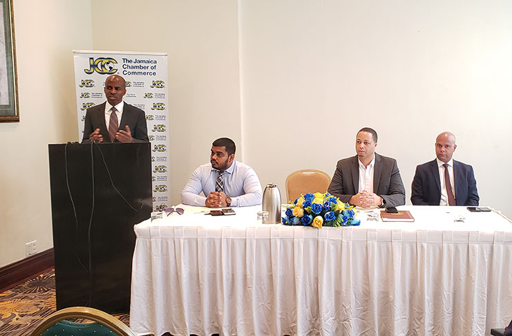 (At podium) JCC President Lloyd Distant Junior addressing the gathering; (seated from left) CEO of GCCI Richard Rambarran; CEO of Go-Invest Owen Verwey and Senior Vice President of GCCI Timothy Tucker.