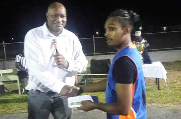 Captain of the Canje Knights, Steve Roopnarine, collects $100,000 from sponsor Nigel Hinds.