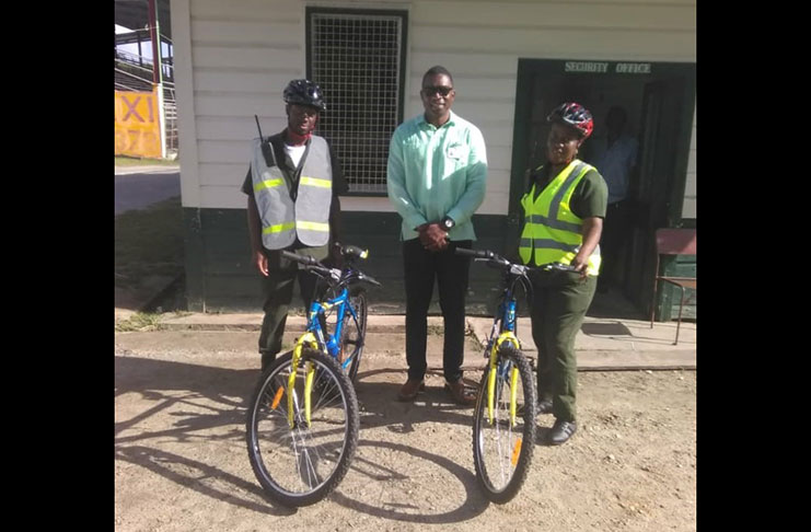 The PAC Security Manager (centre) and two security guards with the bikes used for patrolling the National Park.