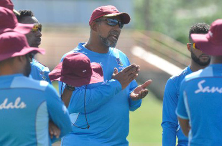 Head coach Phil Simmons (centre) makes a point to his players during a training session yesterday. (Photo courtesy CWI Media)