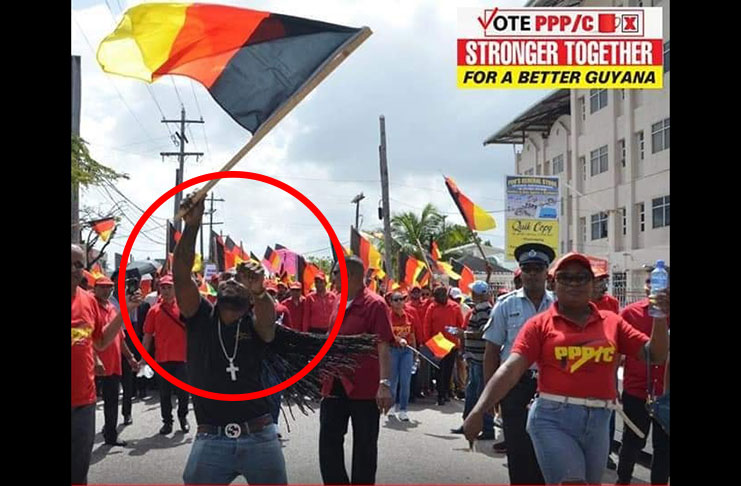 People’s Progressive Party/Civic (PPP/C) member, Sherwin Dalrymple, who allegedly assaulted a teacher last Thursday, is seen here in one of the party’s poster leading the procession