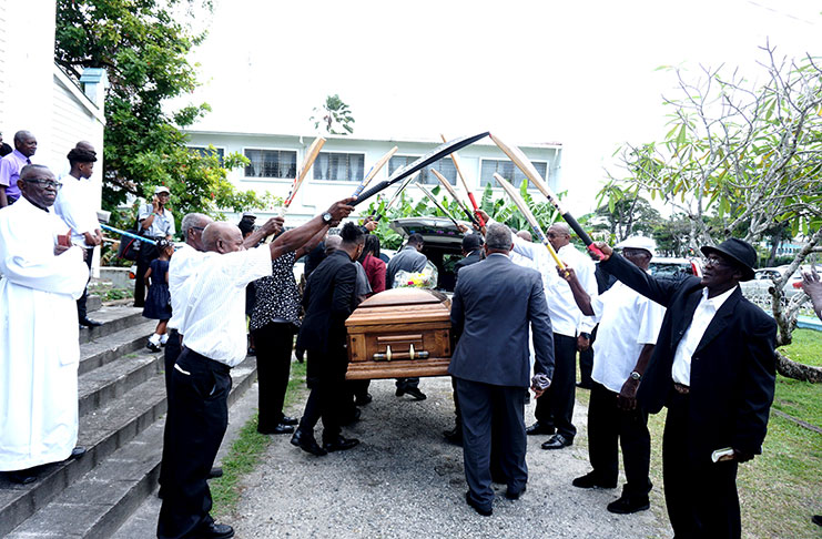 Paul bearers which included some national cricketers guide the casket of the late Basil Butcher to the hearse as with cricket bats forming an arch (Carl Croker Photo)