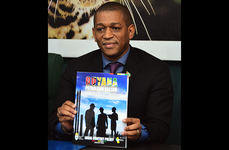 Director of the Department of Energy (DE), Dr. Mark Bynoe holds up a copy of Guyana’s completed Local Content Policy (Adrian Narine photo)