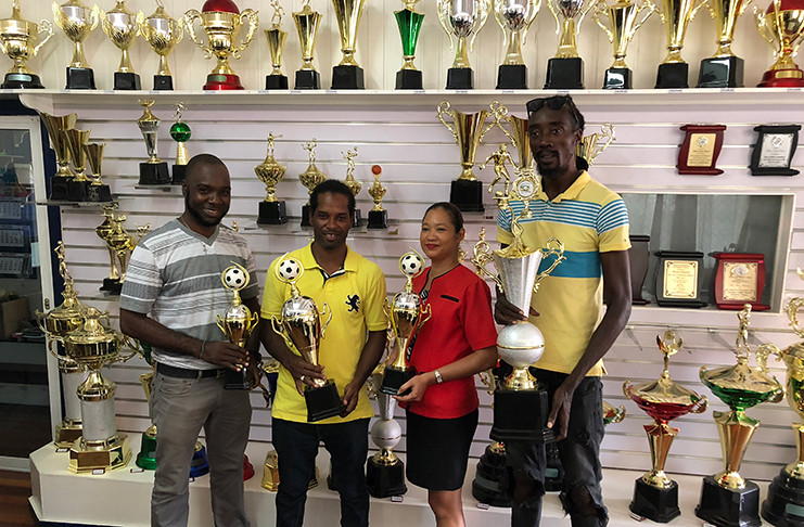 Maria Samaroo, representative of the Woodpecker Trophies and Sport, poses alongside tournament chief Esan Griffith (left), Kingston captain Nigel Denny (2nd left) and Rio All-Stars manager Troy Lambert (right) at the official trophy presentation ceremony.