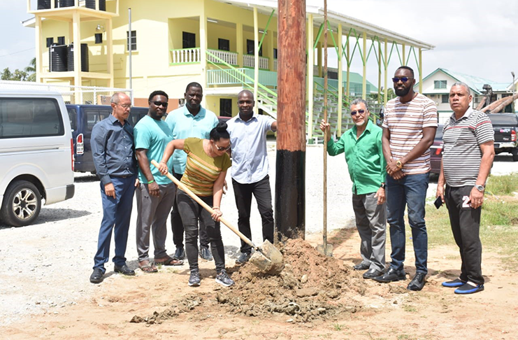 Deputy Mayor of Bartica, Arita Embleton, shovels the base of the newly-installed lights in the presence of Sports Director, Christopher Jones and other BFA and Municipality officials.