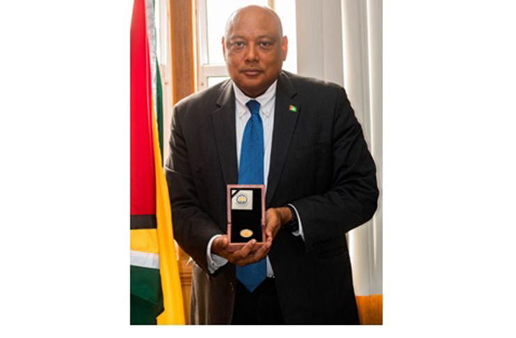 Natural Resources Minister, Rapheal Trotman, with the medallion that will be unveiled on Republic Day