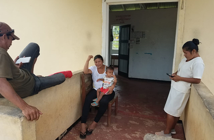 Health Worker at Fairview Health Post, Nyota Peters (right) and another resident connect to the internet with their mobile devices using the Government’s Free Wi-Fi at the Health Post.