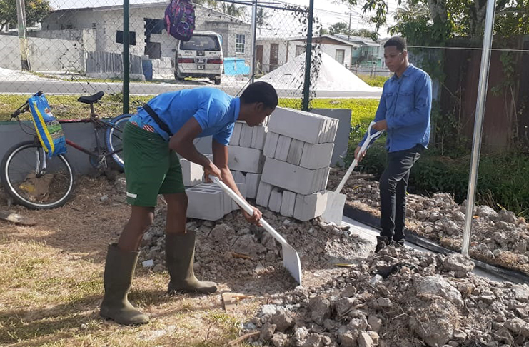 Agricola, the two promising young men hard at work at the construction site at the Agricola Football Field
